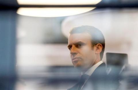 Emmanuel Macron, head of the political movement En Marche !, or Onwards !, and candidate for the 2017 presidential election, is pictured through a window of his hotel during a campaign visit in Rodez, France, May 5, 2017. PHOTO BY REUTERS/Regis Duvignau