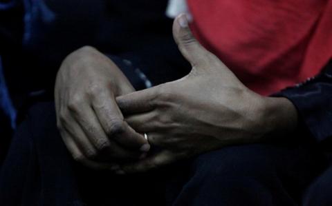 An Eritrean migrant touches a ring on her hand at a military building in Misrata, Libya, November 6, 2016. PHOTO BY REUTERS/Ismail Zitouny