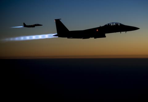 A pair of U.S. Air Force F-15E Strike Eagles fly over northern Iraq after conducting airstrikes in Syria