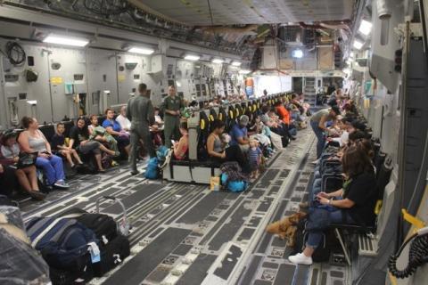 Families settle into their seats aboard a Boeing C-17A Globemaster III aircraft for evacuation from Naval Station Guantanamo Bay ahead of Hurricane Matthew, in Guantanamo Bay, Cuba October 2, 2016 in a photo provided by the U.S. Navy. U.S. Navy/Capt. Frederick H. Agee. PHOTO BY REUTERS