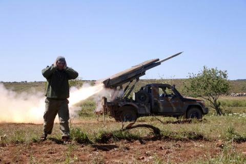 A rebel fighter from the Ahrar al-Sham Islamic Movement reacts as they fire grad rockets from Idlib countryside, towards forces loyal to Syria's President Bashar al-Assad stationed at Jureen town in al-Ghab plain in the Hama countryside, Syria, April 25, 2015. PHOTO BY REUTERS/Mohamad Bayoush