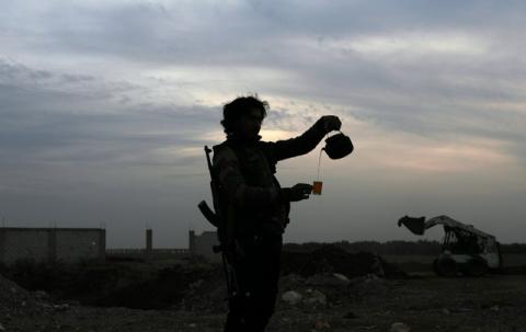 A Free Syrian army fighter pours tea in the rebel-held town of Dael, Syria, December 22, 2017. PHOTO BY REUTERS/Alaa Al-Faqir