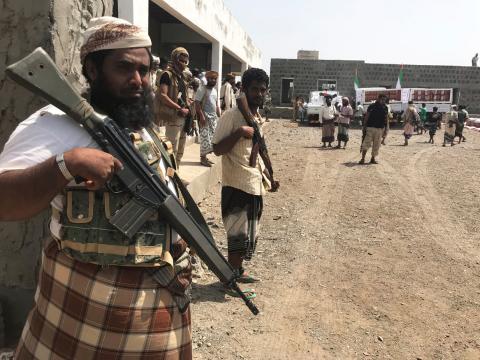 Yemeni fighters secure a building where UAE Red Crescent distribute aid to displaced people in Al-Mokha, Yemen, March 6, 2018. PHOTO BY REUTERS/Aziz El Yaakoubi