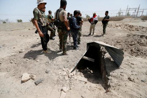 Fighters from the Iraqi Shi'ite Badr Organization stand near a tunnel built by Islamic State fighters on the outskirts of Falluja, Iraq, May 28, 2016. PHOTO BY REUTERS/Thaier Al-Sudani