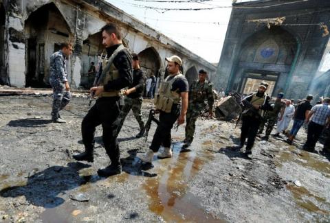 Shi'ite fighters from Saraya al-Salam, who are loyal to radical cleric Muqtada al-Sadr, gather at site of a suicide attack at the entrance of the Shi'ite Mausoleum of Sayid Mohammed bin Ali al-Hadi in Balad, north of Baghdad, Iraq, July 8, 2016. PHOTO BY REUTERS/Thaier Al-Sudani