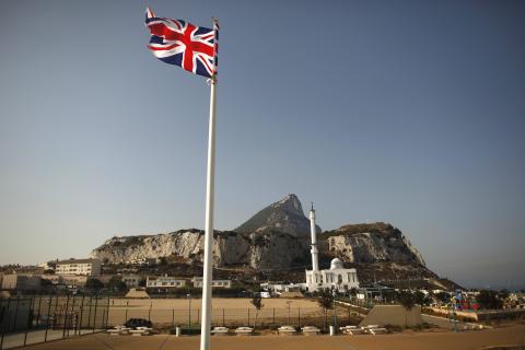 A Union flag flies at Europa Point in front of the Rock (rear), a monolithic limestone promontory, and the Ibrahim-al-Ibrahim mosque in Gibraltar, south of Spain