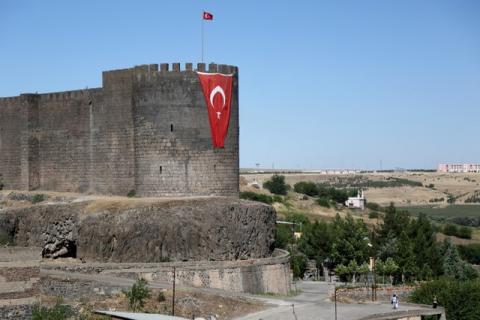 A Turkish flag hangs on the historical city walls at one of the entrance of Sur district in Diyarbakir, Turkey, July 11, 2016. PHOTO BY REUTERS/Sertac Kayar