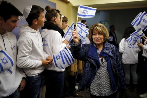 A Jewish immigrant from France arrives for a candle-lighting ceremony to mark the Jewish holiday of Hanukkah, upon landing at Ben Gurion International Airport near Tel Aviv, Israel, December 8, 2015. PHOTO BY REUTERS/Amir Cohen