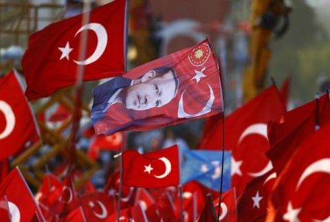 A flag with the picture of Turkey's President Tayyip Erdogan is seen during the Democracy and Martyrs Rally, organized by him and supported by ruling AK Party (AKP), to protest against last month's failed military coup attempt, in Istanbul, Turkey, August 7, 2016. PHOTO BY REUTERS/Osman Orsal
