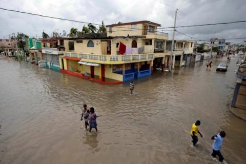 People walk in a flooded area after Hurricane Matthew in Les Cayes, Haiti, October 5, 2016. PHOTO BY REUTERS/Andres Martinez Casares