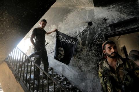 A member of the Syrian Democratic Forces calls his comrades during the fighting with Islamic State fighters in Raqqa, Syria, August 14, 2017. PHOTO BY REUTERS/Zohra Bensemra
