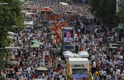 Tens of thousands of people attend a funeral procession to carry the body of Kem Ley, an anti-government figure and the head of a grassroots advocacy group, "Khmer for Khmer" who was shot dead on July 10, to his hometown, in Phnom Penh, Cambodia, July 24, 2016. PHOTO BY REUTERS/Samrang Pring