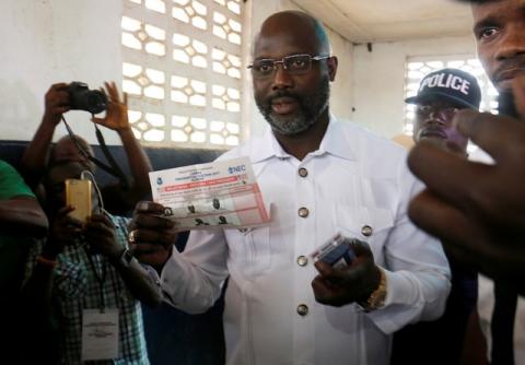George Weah, former soccer player and presidential candidate of Congress for Democratic Change (CDC), prepares his ballot during presidential elections at a polling station in Monrovia, Liberia, December 26, 2017. PHOTO BY REUTERS/Thierry Gouegnon 
