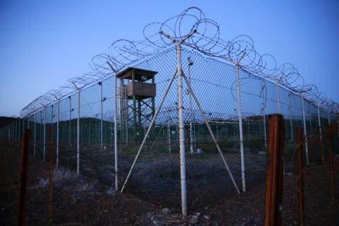 Chain link fence and concertina wire surrounds a deserted guard tower within Joint Task Force Guantanamo's Camp Delta at the U.S. Naval Base in Guantanamo Bay, Cuba, March 21, 2016. PHOTO BY REUTERS/Lucas Jackson