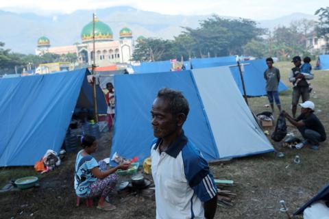 Gumbu, 73, stands with is family outside his tent at a camp for displaced victims of the earthquake and tsunami in Palu, Central Sulawesi, Indonesia, October 9, 2018. PHOTO BY REUTERS/Jorge Silva