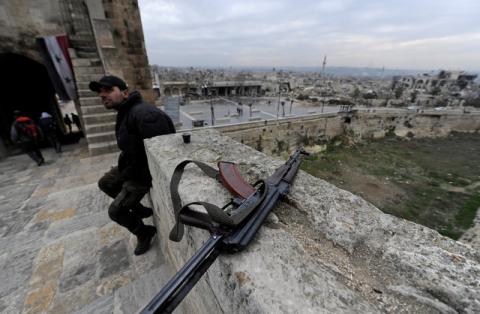 A Syrian army soldier sits near his weapon at Aleppo's historic citadel, in the Old City of Aleppo, Syria, January 31, 2017. PHOTO BY REUTERS/Omar Sanadiki