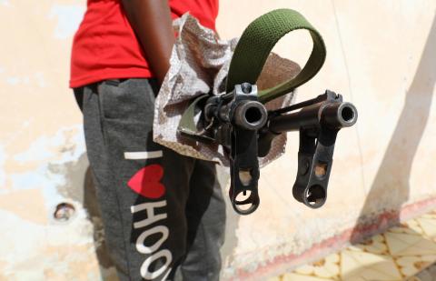A Somali dealer holds weapons looted from a former United Arab Emirates (UAE) military training camp during a Reuters interview in Mogadishu, Somalia, April 25, 2018. PHOTO BY REUTERS/Feisal Omar