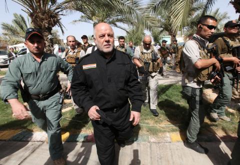 Iraq's Prime Minister Haider al-Abadi (front 2nd L) walks during his visit to an Iraqi army base in Camp Tariq near Falluja, Iraq, June 1, 2016. PHOTO BY REUTERS/Alaa Al-Marjani