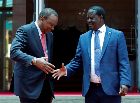 Kenya's President Uhuru Kenyatta (L) greets opposition leader Raila Odinga of the National Super Alliance (NASA) coalition after addressing a news conference at the Harambee house office in Nairobi, Kenya, March 9, 2018. PHOTO BY REUTERS/Thomas Mukoya