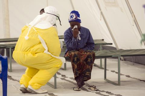 A health worker wearing protective gear attends to a newly admitted suspected Ebola patient in a quarantine zone at a Red Cross facility in the town of Koidu, Kono district in Eastern Sierra Leone, December 19, 2014. PHOTO BY REUTERS/Baz Ratner