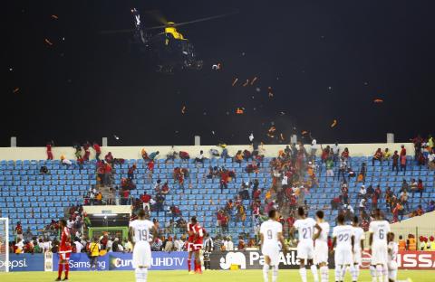 A police helicopter hovers over Equitorial Guinea fans as they throw objects during the 2015 African Cup of Nations semi-final soccer match against Ghana in Malabo, Equatorial Guinea, February 5, 2015. PHOTO BY REUTERS/Amr Abdallah Dalsh
