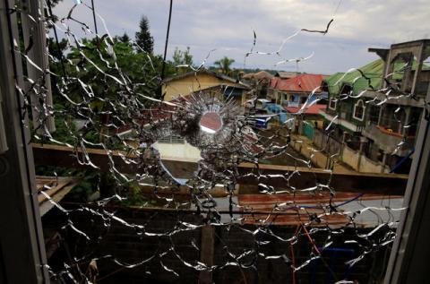 An abandoned hospital window is seen full of bullet holes, as government soldiers continue their assault against the Maute group in Marawi City, Philippines, June 12, 2017. PHOTO BY REUTERS/Romeo Ranoco