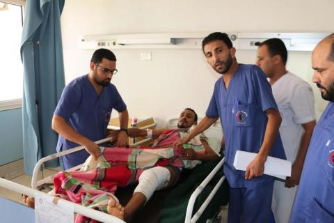 A man (C) lies in a bed at Sbaah hospital, after he was injured in a shelling in Qaser Bin Ghashir, near the Tripoli International Airport, July 26, 2014. PHOTO BY REUTERS/Hani Amara