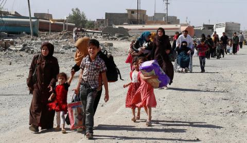 Residents who fled their homes due to fighting between Iraqi forces and Islamic State militants return to their village cleared by the Iraqi forces in western Mosul in Iraq, June 7, 2017. PHOTO BY REUTERS/Erik De Castro