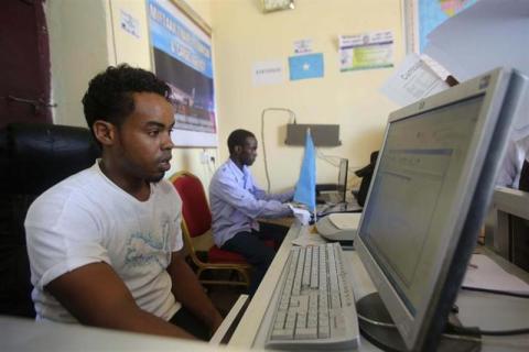 An internet cafe manager uses a computer in an internet cafe in the Hodan area of Mogadishu