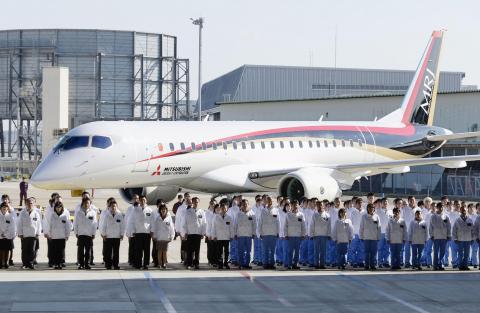 A Mitsubishi Regional Jet (MRJ) is unveiled at the hanger for its roll out ceremony at Mitsubishi Heavy Industries' Nagoya Aerospace Systems Works Komaki Minami Plant in Toyoyama town, Nagoya prefecture