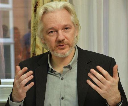 WikiLeaks founder Julian Assange gestures during a news conference at the Ecuadorian embassy in central London, August 18, 2014. PHOTO BY REUTERS/John Stillwell