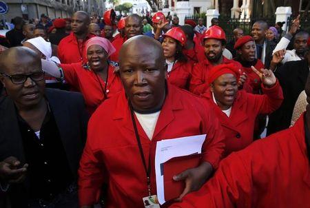 Julius Malema, leader of the opposition Economic Freedom Fighters (EFF), leaves parliament with supporters in Cape Town, August 21, 2014. PHOTO BY REUTERS/Mike Hutchings