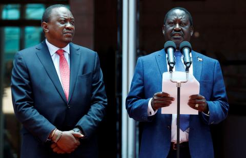 Kenya's opposition leader Raila Odinga of the National Super Alliance (NASA) coalition flanked by Kenya's President Uhuru Kenyatta (L) address a news conference after meeting at the Harambee house office in Nairobi, Kenya, March 9, 2018. PHOTO BY REUTERS/Thomas Mukoya