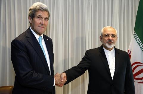 U.S. Secretary of State John Kerry shakes hands with Iranian Foreign Minister Mohammad Javad Zarif before a meeting in Geneva, January 14, 2015. PHOTO BY REUTERS/Rick Wilking