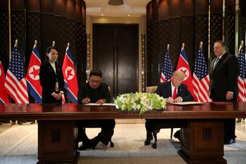 U.S. President Donald Trump and North Korea's leader Kim Jong Un sign documents that acknowledge the progress of the talks and pledge to keep momentum going, after their summit at the Capella Hotel on Sentosa island in Singapore, June 12, 2018. PHOTO BY REUTERS/Jonathan Ernst