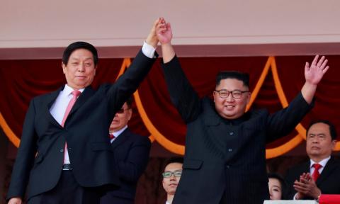 North Korean leader Kim Jong Un and China's Li Zhanshu, chairman of the Standing Committee of the National People's Congress (NPC), wave to people while attending a military parade marking the 70th anniversary of North Korea's foundation in Pyongyang, North Korea, September 9, 2018. PHOTO BY REUTERS/Danish Siddiqui