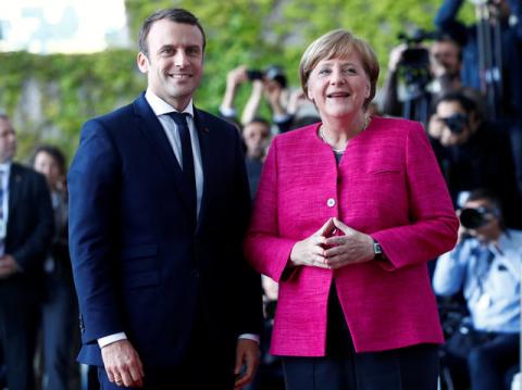 German Chancellor Angela Merkel and French President Emmanuel Macron arrive at a ceremony at the Chancellery in Berlin, Germany, May 15, 2017. PHOTO BY REUTERS/Fabrizio Bensch