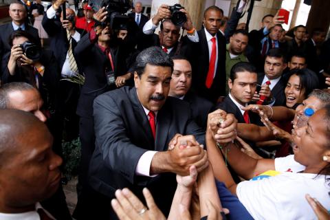 Venezuela's re-elected President Nicolas Maduro greets his supporters as he leaves after receiving a certificate confirming him as winner of Sunday's election at the National Electoral Council (CNE) in Caracas, Venezuela, May 22, 2018. PHOTO BY REUTERS/Carlos Garcia Rawlins