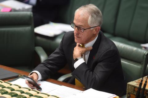 Australia's Prime Minister Malcolm Turnbull looks at his phone during House of Representatives Question Time in Parliament House, Canberra, Australia, November 9, 2016. PHOTO BY REUTERS/Lukas Coch