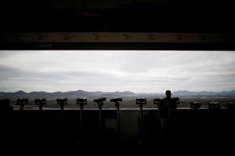 A man stands near binoculars as he tries to see North Korea's propaganda village of Gijungdong at the Dora observatory near the demilitarised zone separating the two Koreas, in Paju, South Korea, April 24, 2018. PHOTO BY REUTERS/Kim Hong-Ji