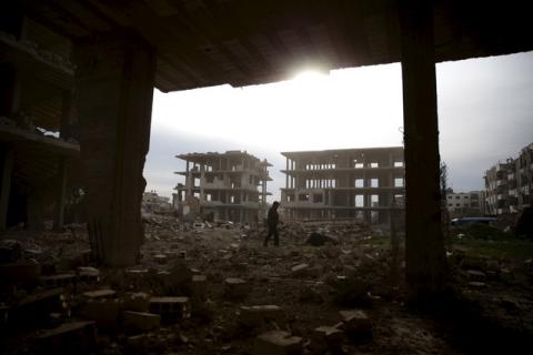 A man walks on the rubble of damaged buildings in the rebel-controlled area of Jobar, a suburb of Damascus, Syria, March 2, 2016. PHOTO BY REUTERS/Bassam Khabieh