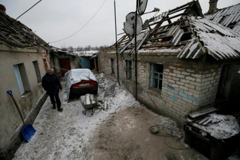 A man is seen in front of his building, which was damaged during fighting between the Ukrainian army and pro-Russian separatists, in the government-held industrial town of Avdiyivka, Ukraine, February 2, 2017. PHOTO BY REUTERS/Gleb Garanich