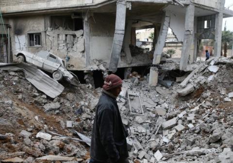 A man is seen near rubble of damaged buildings after an airstrike on the Eastern Ghouta town of Misraba, Syria, January 4, 2018. PHOTO BY REUTERS/Bassam Khabieh