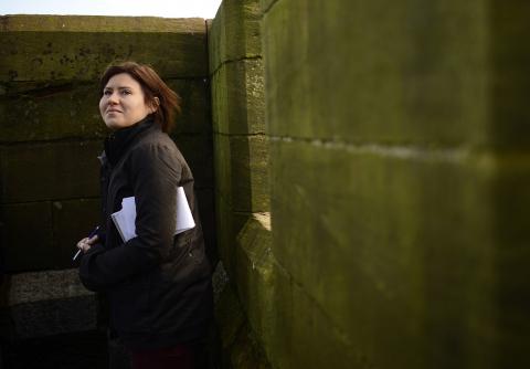 Reuters reporter Maria Golovnina stands atop a church steeple, while on assignment in Dalton-in-Furness, northern England, September 26, 2012. PHOTO BY REUTERS/Dylan Martinez