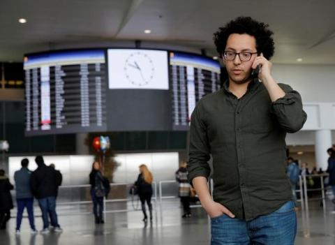 Mark Doss, Supervising Attorney for the International Refugee Assistance Project at the Urban Justice Center speaks on his cell phone at John F. Kennedy International Airport in Queens, New York, U.S., January 28, 2017. PHOTO BY REUTERS/Andrew Kelly
