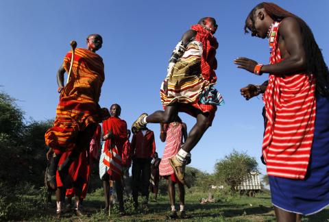 Maasai men sing traditional songs and jump before the Maasai Olympics 2014 at the Sidai Oleng wildlife sanctuary at the base of Mt. Kilimanjaro near the Kenya-Tanzania border in Kajiado, December 13, 2014. PHOTO BY REUTERS