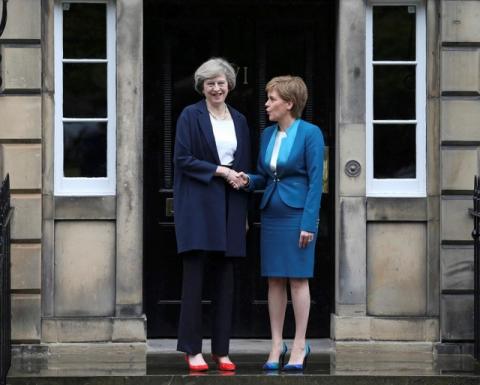 Scotland's First Minister, Nicola Sturgeon (R), greets Britain's new Prime Minister, Theresa May, as she arrives at Bute House in Edinburgh, Scotland, Britain, July 15, 2016. PHOTO BY REUTERS/Russell Cheyne