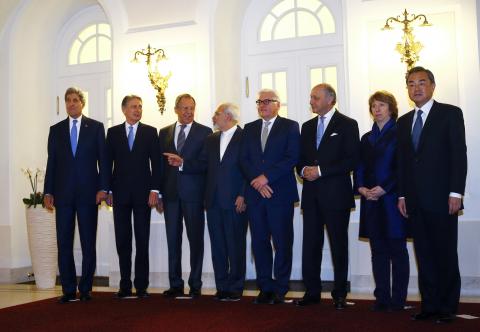 U.S. Secretary of State John Kerry, Britain's Foreign Secretary Philip Hammond, Russian Foreign Minister Sergei Lavrov, Iranian Foreign Minister Javad Zarif, German Foreign Minister Frank-Walter Steinmeier, French Foreign Minister Laurent Fabius, EU envoy Catherine Ashton and Chinese Foreign Minister Wang Yi (LtoR) pose for photographers before a meeting in Vienna, November 24, 2014. PHOTO BY REUTERS/Leonhard Foeger