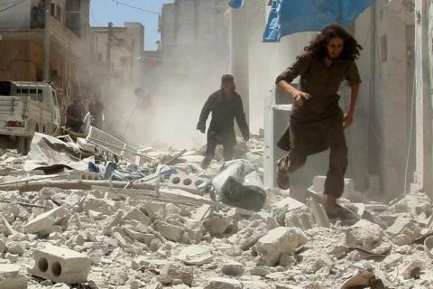 Men make their way through the rubble of damaged buildings at a site hit by air strikes in Idlib city, Syria, July 20, 2016. PHOTO BY REUTERS/Ammar Abdullah