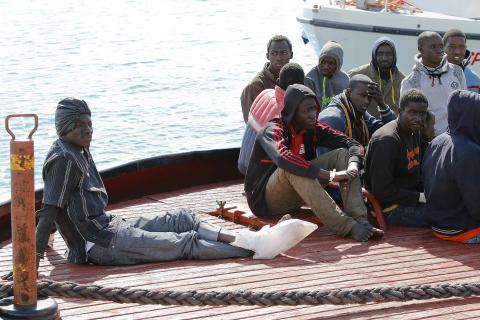 Migrants arrive by boat at the Sicilian harbour of Pozzallo, February 15, 2015. PHOTO BY REUTERS/Antonio Parrinello